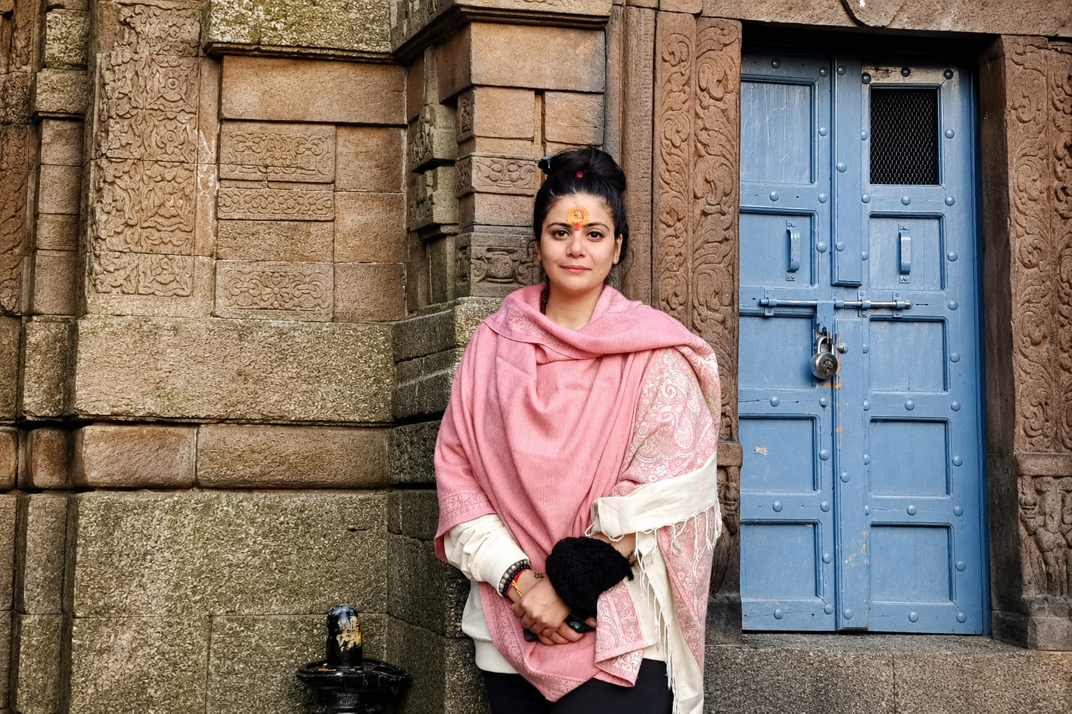 Healer Bhairavi Sharma standing at the entrance of a temple